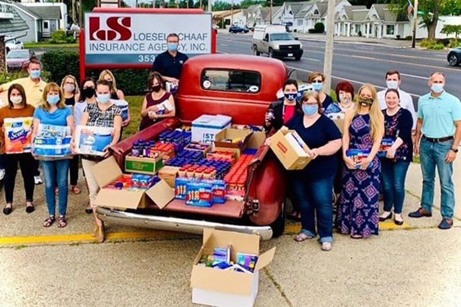 Nonprofit - Loesel-Schaaf Insurance Agency Giving Back Portrait Donating Food from the Back of a Pickup Truck on a Sunny Day - Small