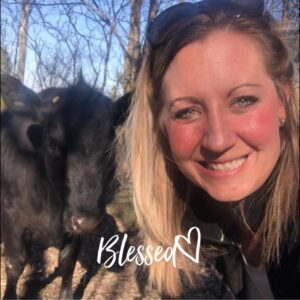 Team - Sara Corwin with a cow behind her