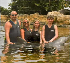 Paula and family swimming with the dolphins